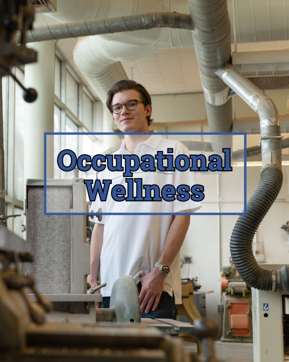 A student wearing a white lab coat and goggles pictured next to lab equipment machinery